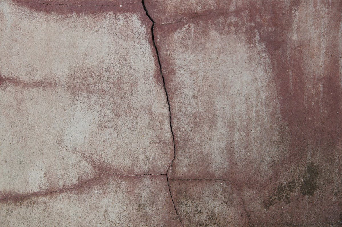 Close-up of concrete wall crack being assessed for repair method in Essex County
